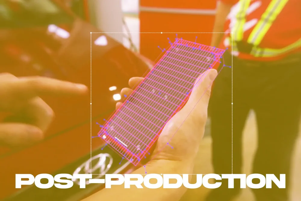 A hand holding a smartphone during post-production