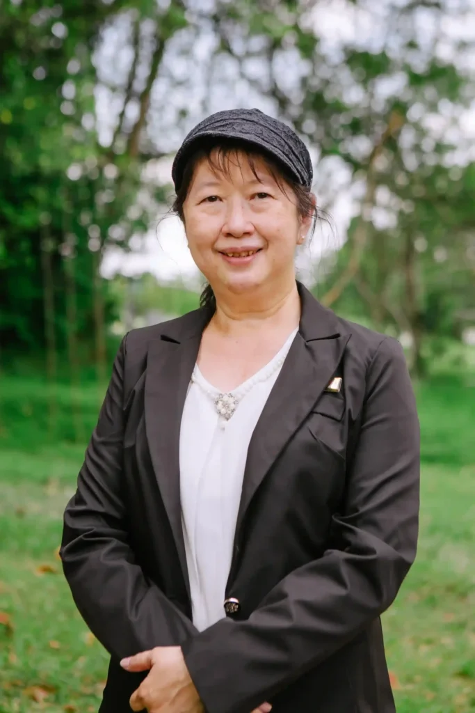 Woman in a black suit smiling to camera